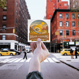 Earthwide_Solar_Cooking_Festival__Confe_WhiteSquareSticker_Hand_Mockup.png_16183540